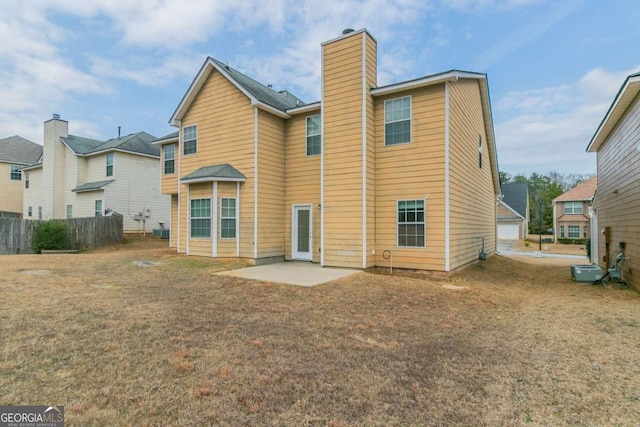 back of house with a patio area and a lawn