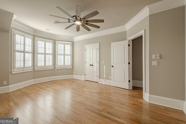 spare room featuring crown molding, ceiling fan, and light wood-type flooring