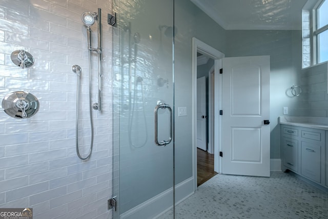 bathroom featuring crown molding and a shower with door