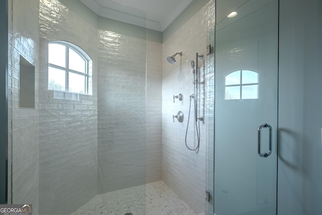 bathroom with a shower with door