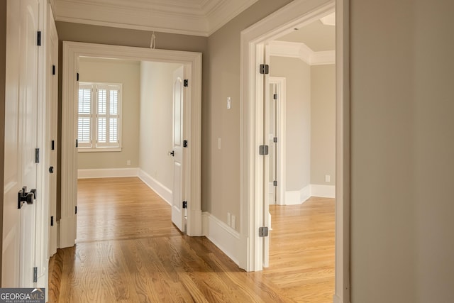 hall featuring ornamental molding and light wood-type flooring