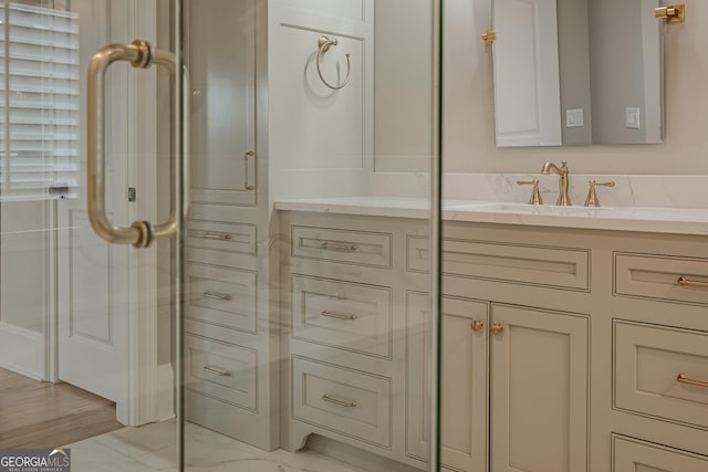 bathroom featuring vanity and a shower with shower door