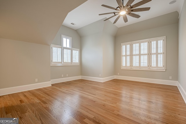 interior space featuring ceiling fan, vaulted ceiling, and light hardwood / wood-style flooring