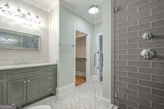 bathroom featuring vanity, an enclosed shower, and crown molding