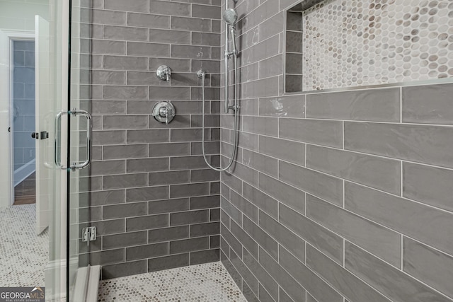 bathroom featuring a shower with door