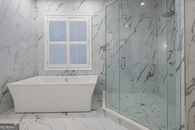 bathroom featuring shower with separate bathtub