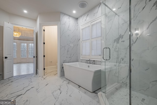 bathroom featuring a chandelier and independent shower and bath