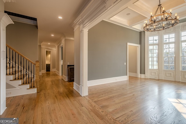 entryway with decorative columns, beamed ceiling, ornamental molding, coffered ceiling, and light hardwood / wood-style flooring