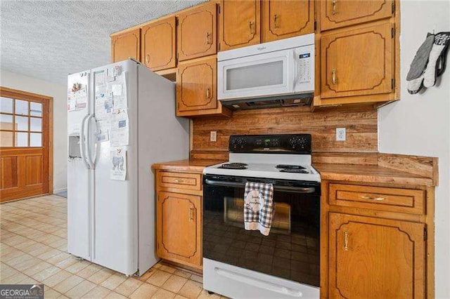 kitchen with white appliances and a textured ceiling