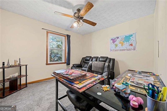 carpeted home office with ceiling fan and a textured ceiling