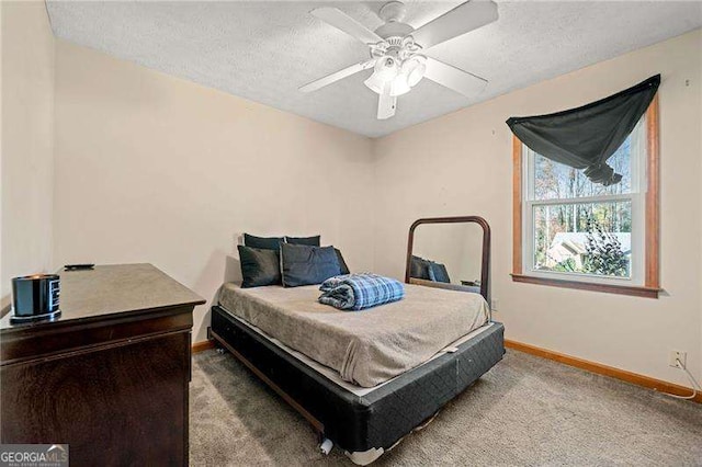 bedroom featuring ceiling fan, carpet flooring, and a textured ceiling