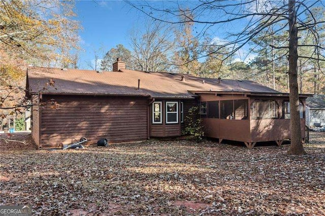 back of property with a sunroom