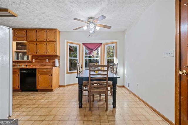 dining space with ceiling fan and a textured ceiling