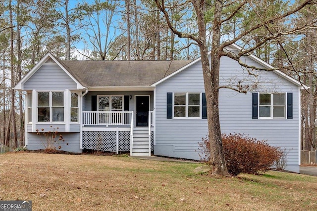 single story home with a front lawn and covered porch