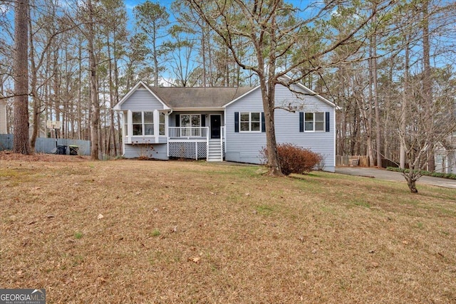 view of front of property featuring a front yard and covered porch