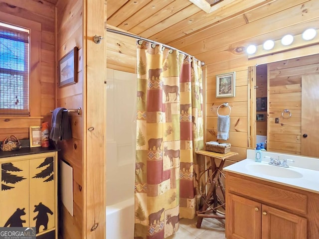 bathroom featuring wooden walls, wooden ceiling, vanity, tile patterned floors, and shower / bath combo with shower curtain