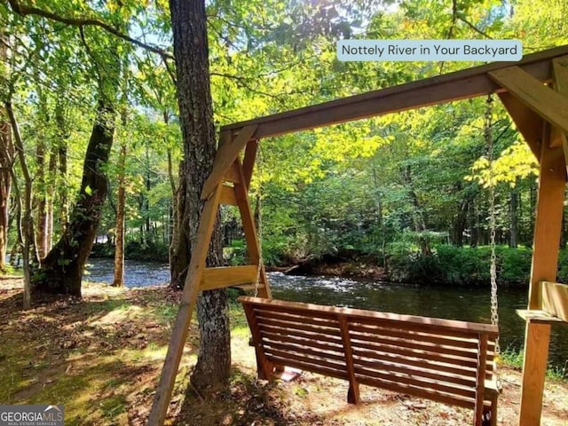 exterior space with a view of trees and a water view