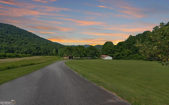 view of street with a forest view and a mountain view