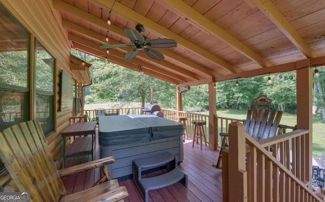 wooden deck featuring a hot tub and ceiling fan