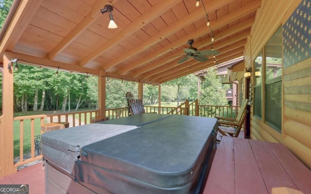 wooden terrace with a hot tub and ceiling fan