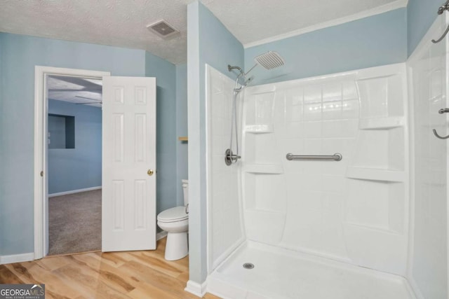 full bathroom with visible vents, a textured ceiling, toilet, and wood finished floors