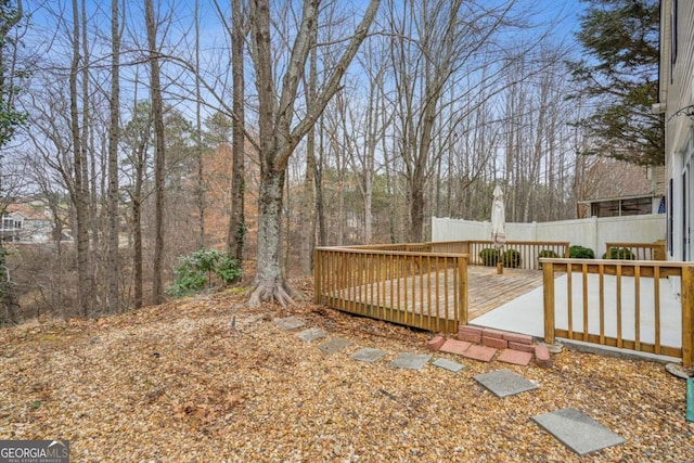 view of yard with fence and a deck