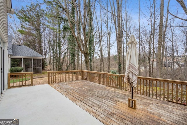 wooden deck with a sunroom