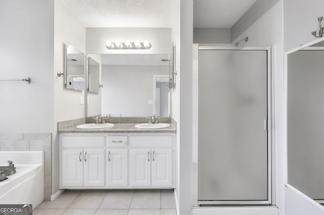 bathroom with vanity, tile patterned floors, a textured ceiling, and separate shower and tub