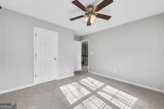 unfurnished bedroom featuring light colored carpet and ceiling fan