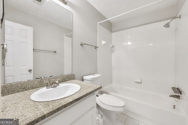 full bathroom with toilet, tiled shower / bath, a textured ceiling, vanity, and tile patterned flooring