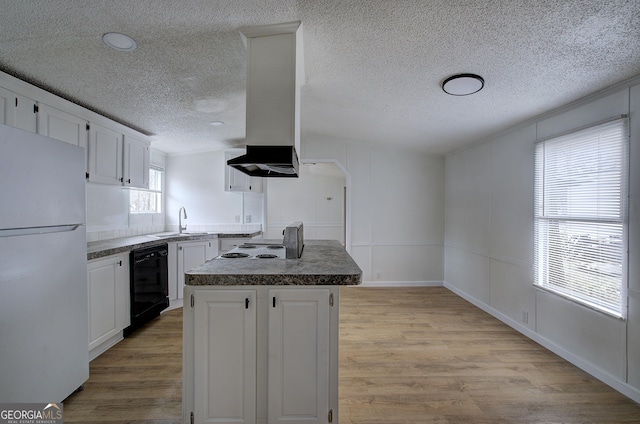 kitchen featuring white refrigerator, dishwasher, a center island, and white cabinets