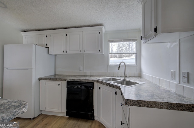 kitchen featuring white refrigerator, dishwasher, sink, and white cabinets