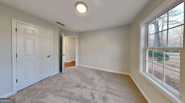 unfurnished bedroom featuring light carpet