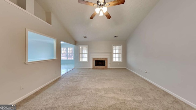 unfurnished living room with light carpet, a fireplace, high vaulted ceiling, and ceiling fan