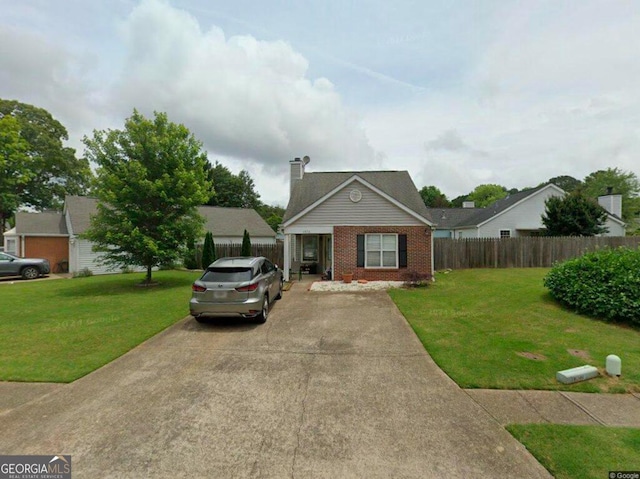 bungalow-style house with a front yard, brick siding, fence, and a chimney