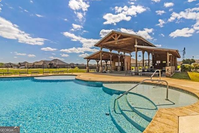 community pool with a patio area