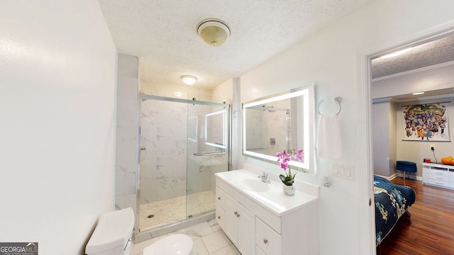 bathroom featuring vanity, toilet, a textured ceiling, and walk in shower