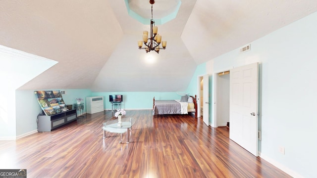 bedroom featuring an inviting chandelier, lofted ceiling, and dark hardwood / wood-style flooring