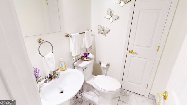 bathroom featuring sink and toilet