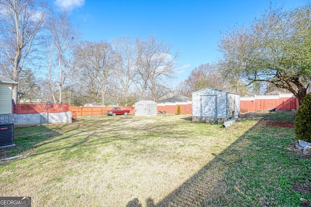 view of yard with a storage shed and central air condition unit