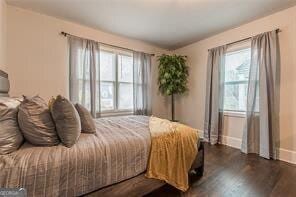 bedroom with dark wood-type flooring