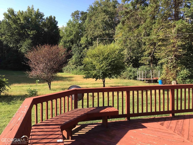 wooden deck with a lawn