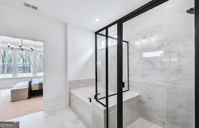 bathroom featuring independent shower and bath and a chandelier