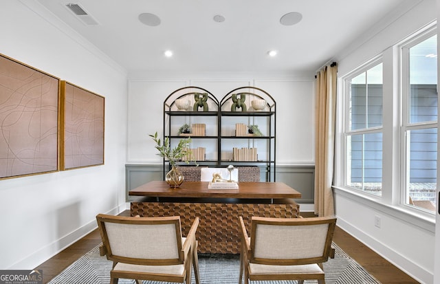 dining room featuring dark hardwood / wood-style flooring, a baseboard radiator, and ornamental molding