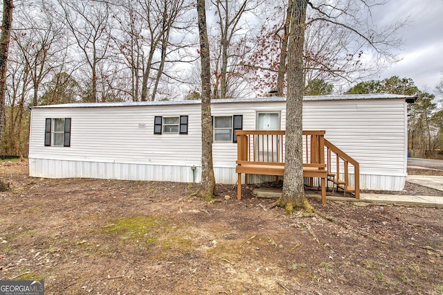 back of house featuring a deck