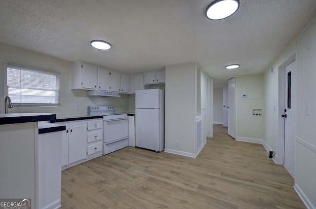 kitchen featuring white appliances, light hardwood / wood-style floors, a textured ceiling, and white cabinets