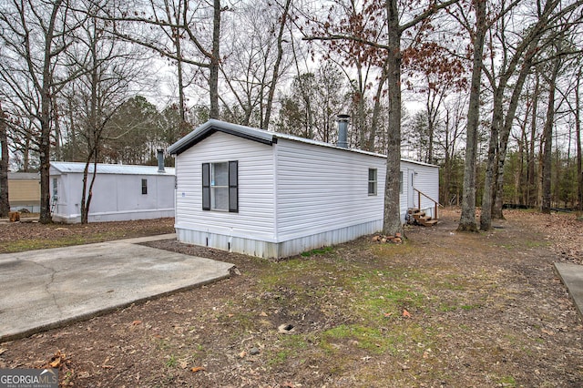 view of side of property with a patio area