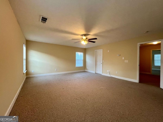 empty room featuring ceiling fan and carpet flooring