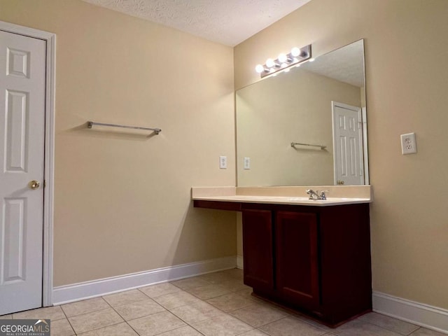 bathroom featuring vanity, tile patterned floors, and a textured ceiling