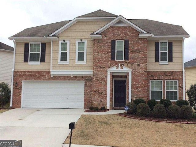 view of front of house with a garage and a front yard